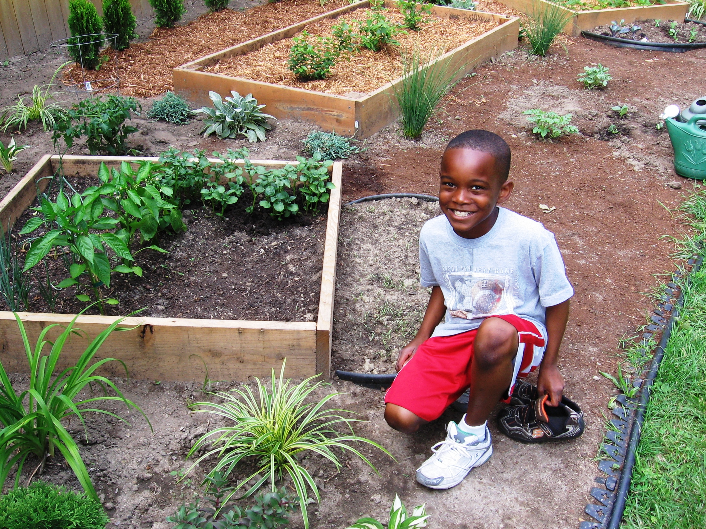 A young Chris in the original garden — the 9-year-old who drew the first blueprint